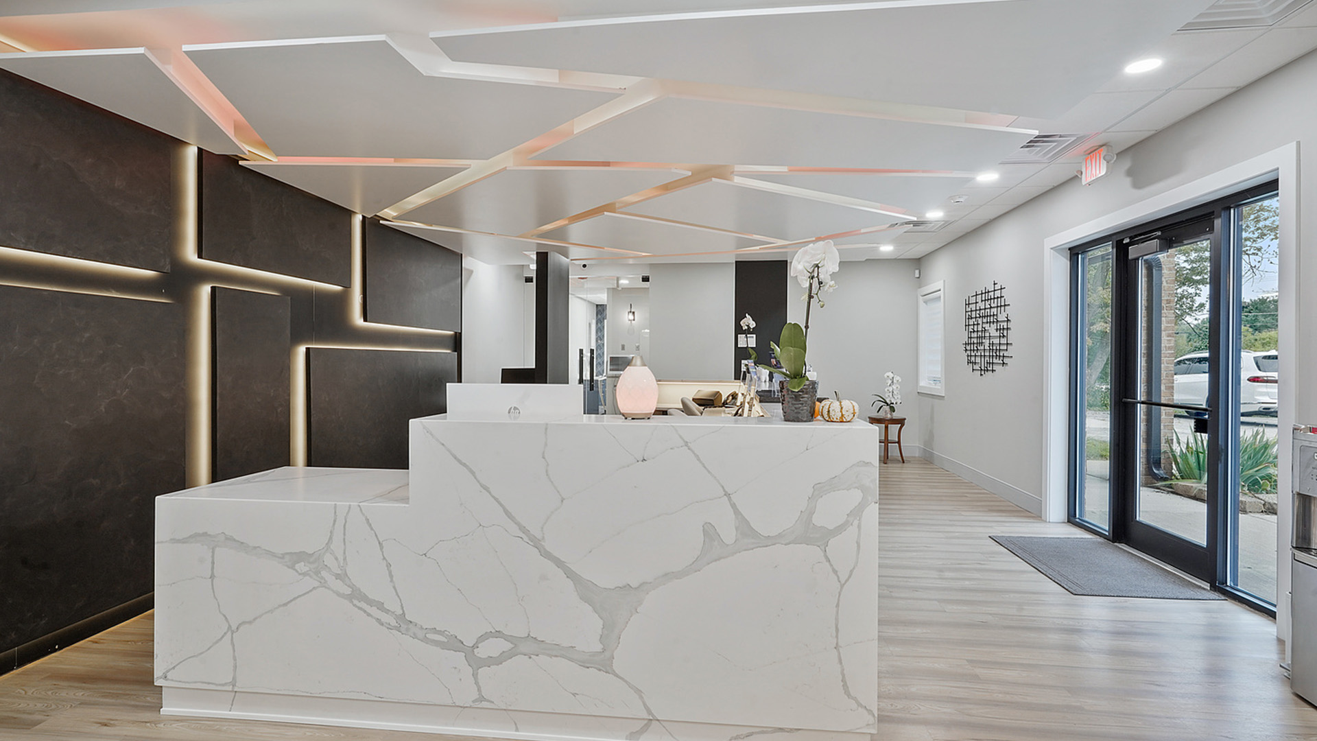 An interior view of a modern, minimalist office space with a marble countertop and contemporary decor.